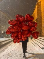 Osoba z balonami w serca